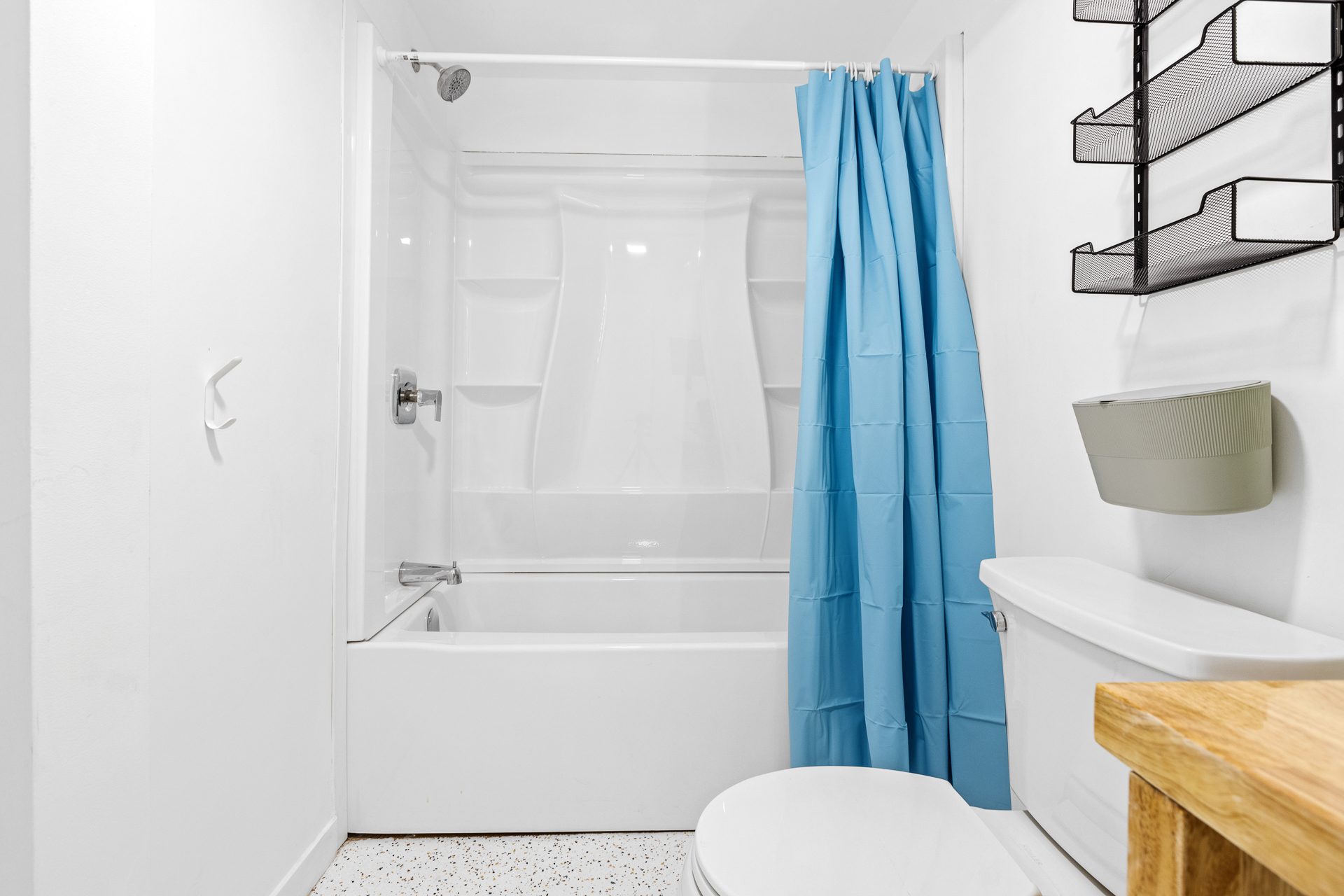 Unit 06 tub shower and bathroom storage shelving