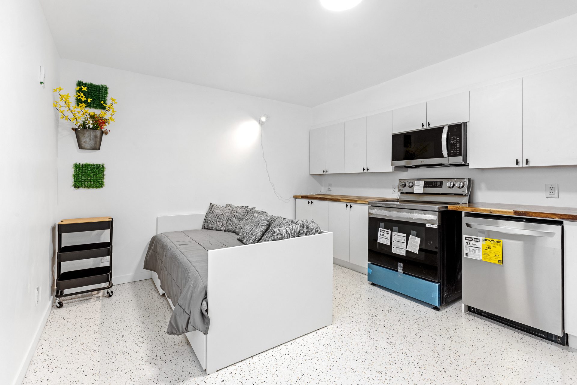 Unit 06 kitchen wall with sleeping area in view