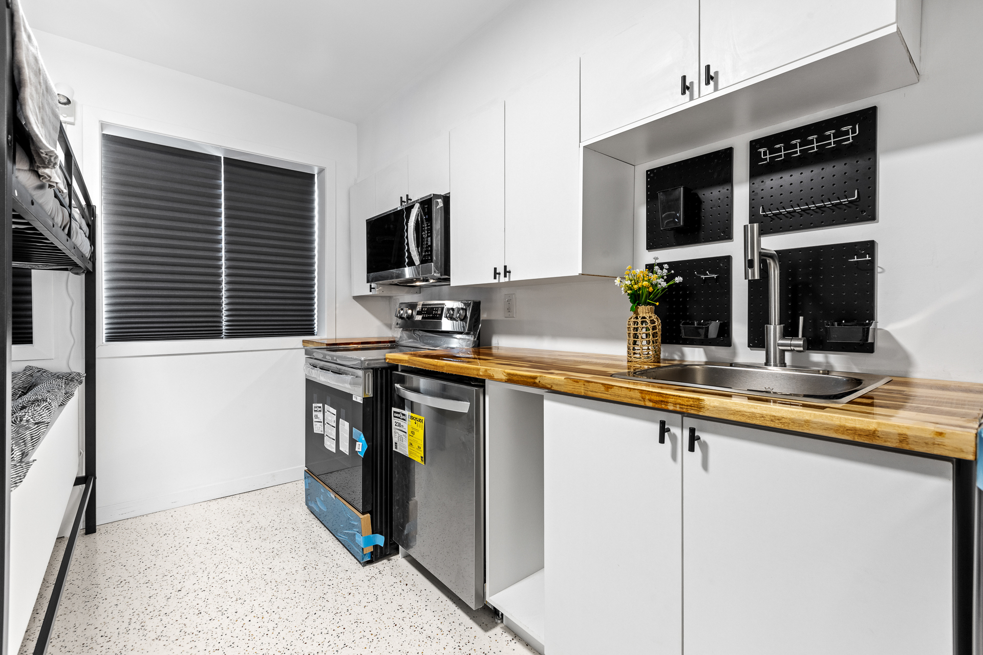 Unit 09 kitchen with butcher block counter and black appliances