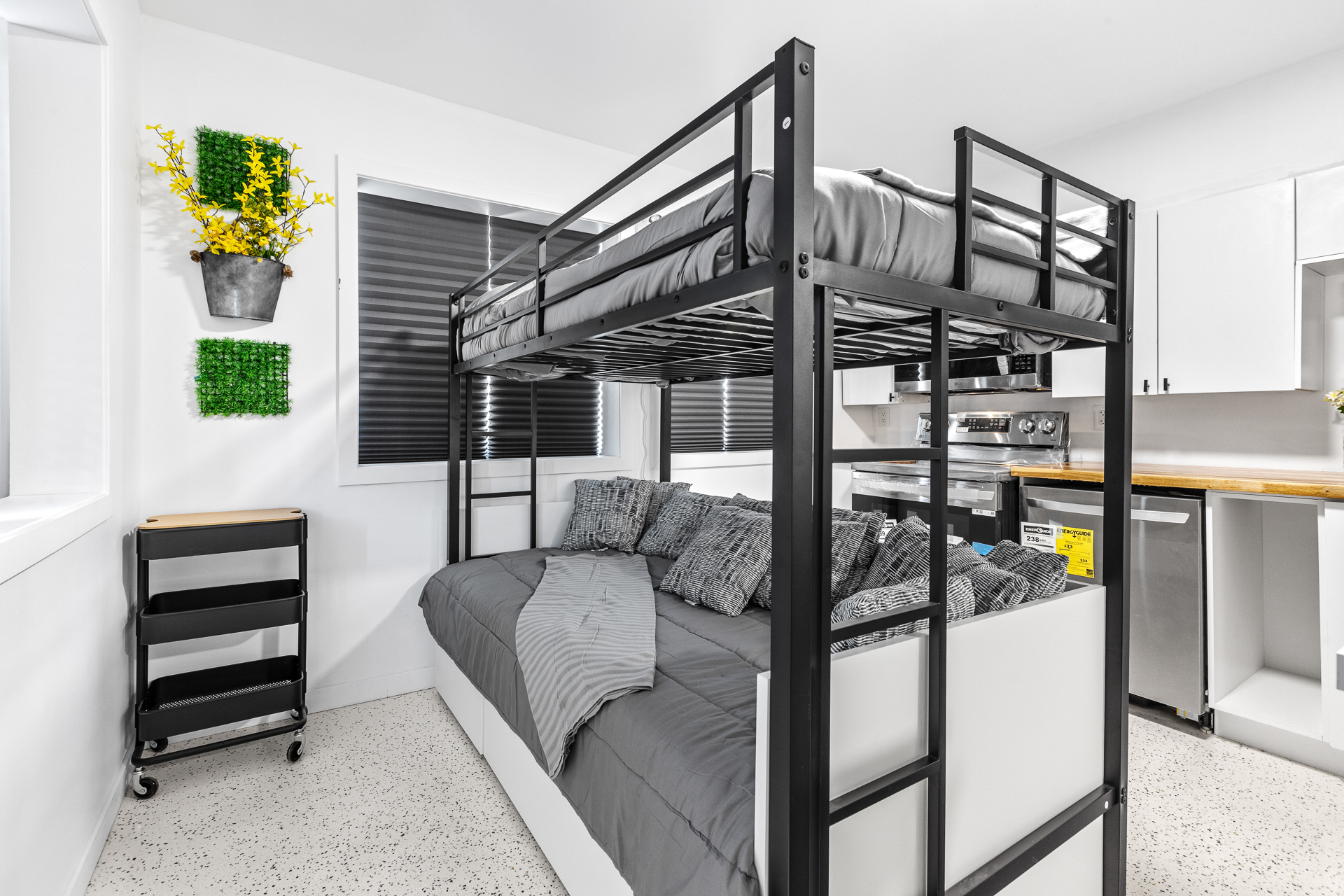 Unit 09 living area with loft bed over daybed beside the kitchen